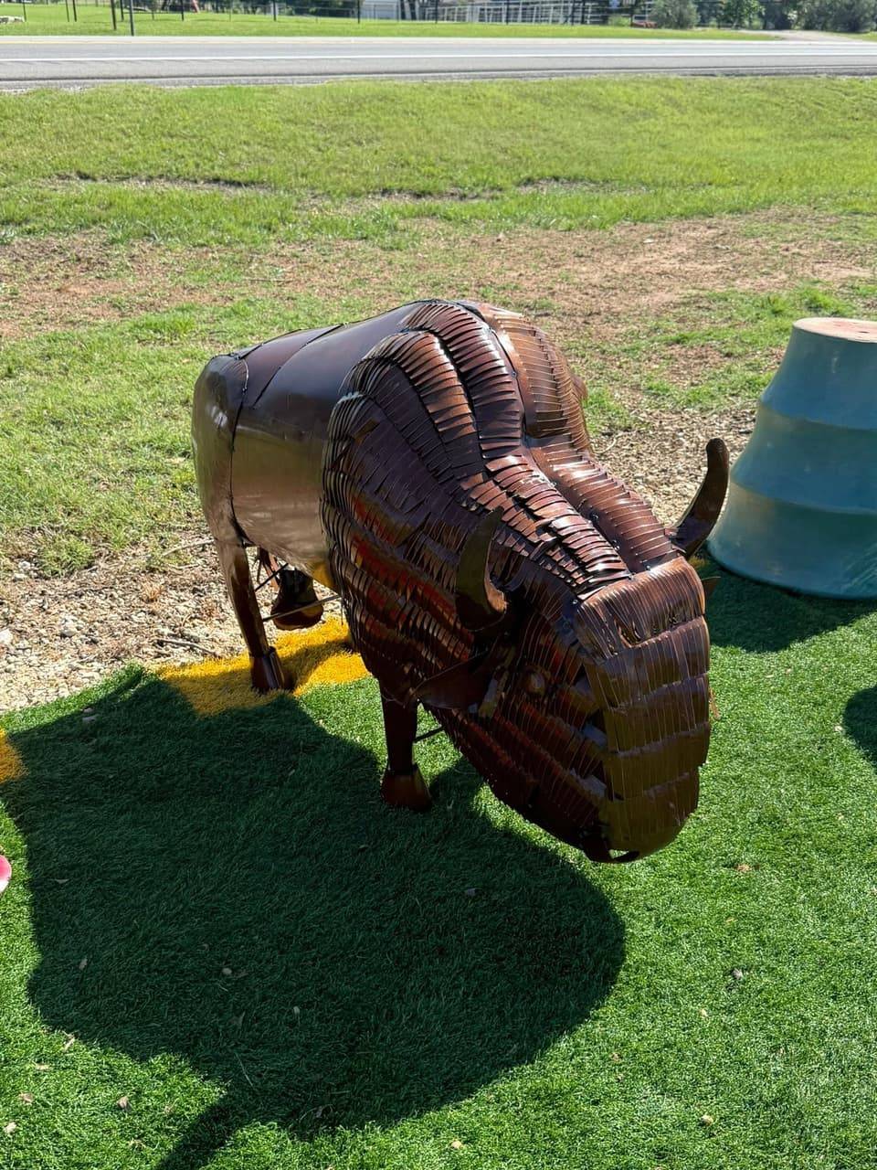 Metal buffalo sculpture on the lawn at Pick Ur Pots in Stephenville, TX
